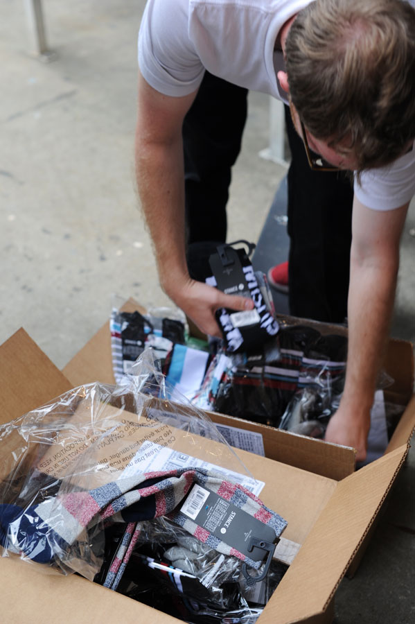 A box of Stance socks is gold on a skateboard